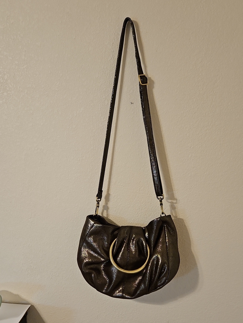 Hobo Metallic Brown Leather Hobo Bag with Brass Accents and Detachabke Strap.